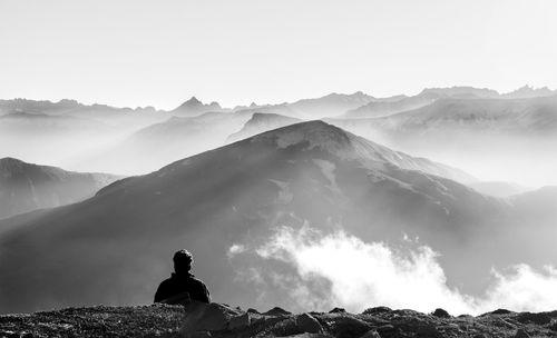 High angle view of man against mountains during foggy weather