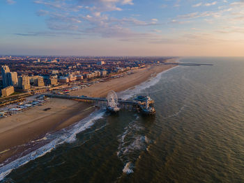 High angle view of cityscape by sea against sky