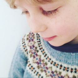 Close-up of cute boy against white background