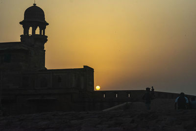 Silhouette building against sky during sunset