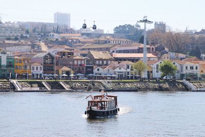 Boat in river with town in background