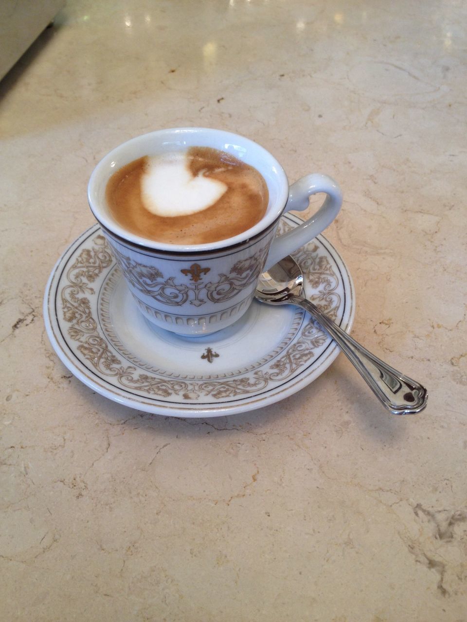 drink, coffee cup, table, indoors, high angle view, still life, refreshment, coffee - drink, food and drink, saucer, close-up, no people, coffee, frothy drink, metal, spoon, cup, directly above, day, cappuccino