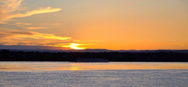 Scenic view of river at sunset