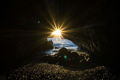 Scenic view of sea against bright sun