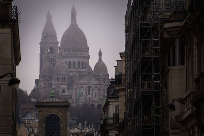 Misty sacre coeur from the streets of paris, france