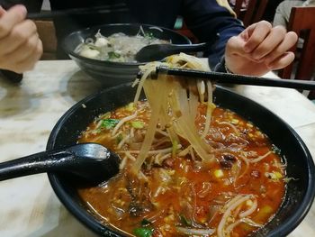 Close-up of man preparing food on table