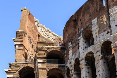 Low angle view of colosseum against sky