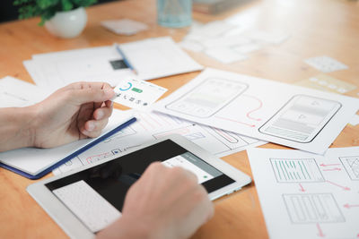 Cropped image of business colleagues working on table