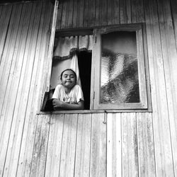 Portrait of girl standing by window