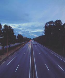 Road amidst trees against sky