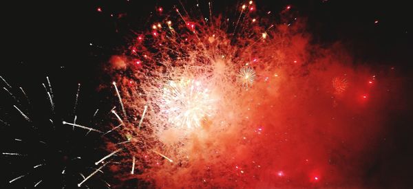 Low angle view of firework display at night