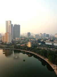 River amidst buildings against sky in city