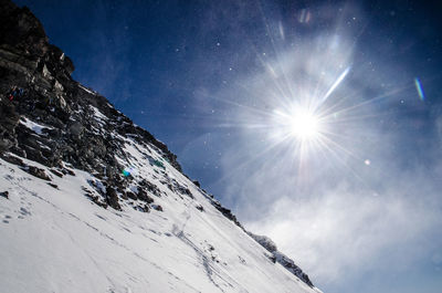 Low angle view of mountain against sky during winter