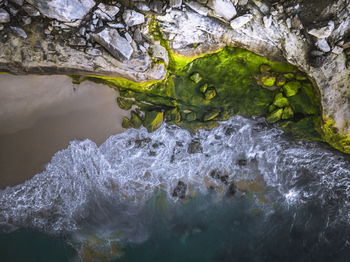 High angle view of water flowing through rocks