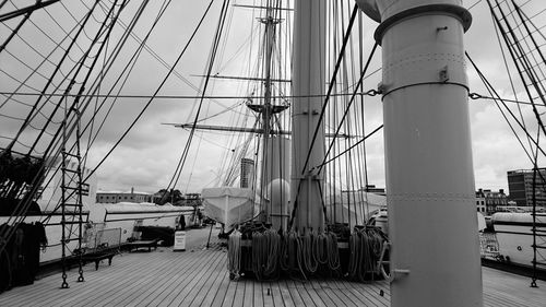 Sailboats moored at harbor