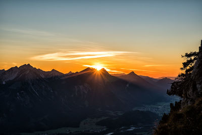 Scenic view of snowcapped mountains against sky during sunset