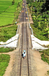 Man walking on the railroad tracks