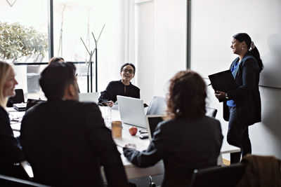 Smiling business people during meeting in office