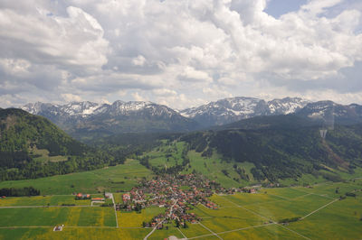 Scenic view of landscape against cloudy sky