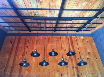 Low angle view of pendant lights hanging from ceiling