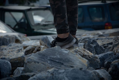 Low section of person standing on rocks