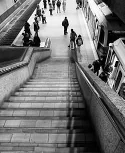 High angle view of people walking on staircase