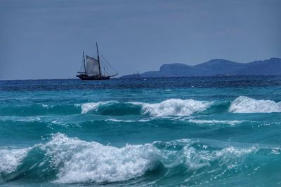 Sailboat sailing in sea against sky