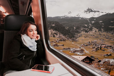 Woman looking through train window