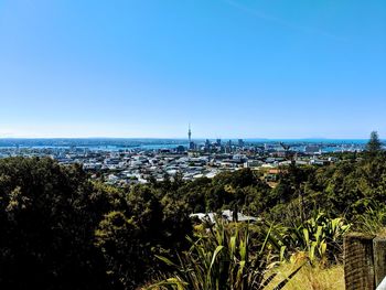 Scenic view of townscape against clear blue sky