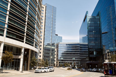 Modern buildings in city against clear sky