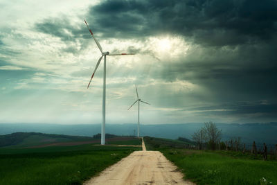 Windmill on field against sky