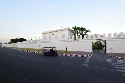 Road by building against sky