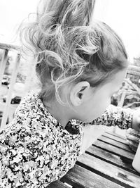 Close-up of cute girl sitting outdoors