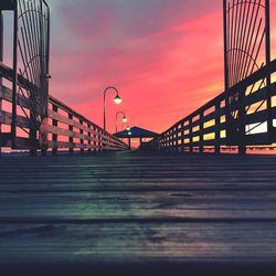 Bridge in city against sky during sunset