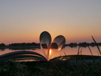 Close-up of heart shape against sunset sky