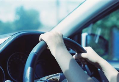 Cropped image of woman driving car