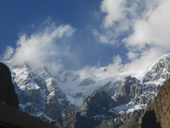 Scenic view of snow covered mountains against sky