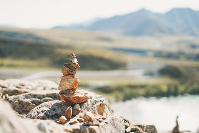 Pile of stones pyramid on background of the altai mountains and katun river