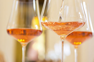 Glasses with rose wine in a festive room for a celebration - selective focus