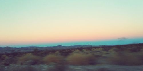 Scenic view of landscape against clear sky during sunset