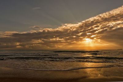 Scenic view of beach against sky during sunset