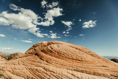 Circular patterns of petrified sand dunes on red rock in utah desert