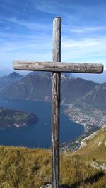 Cross on land against sky