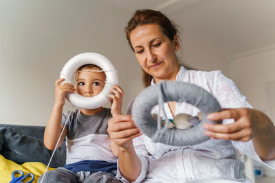 View of mother and son sitting at home