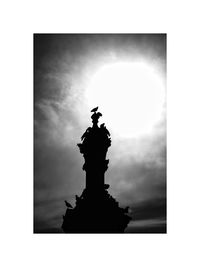 Low angle view of statue against cloudy sky