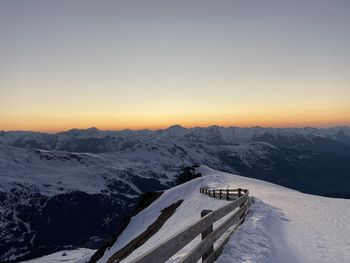 Scenic view of snow covered mountains against sky during sunset