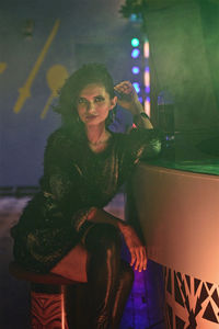 Full length of woman sitting at night