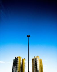 Low angle view of modern building against blue sky