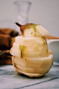 Close-up of sliced pear stack on table