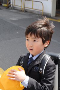 Portrait of cute boy standing outdoors